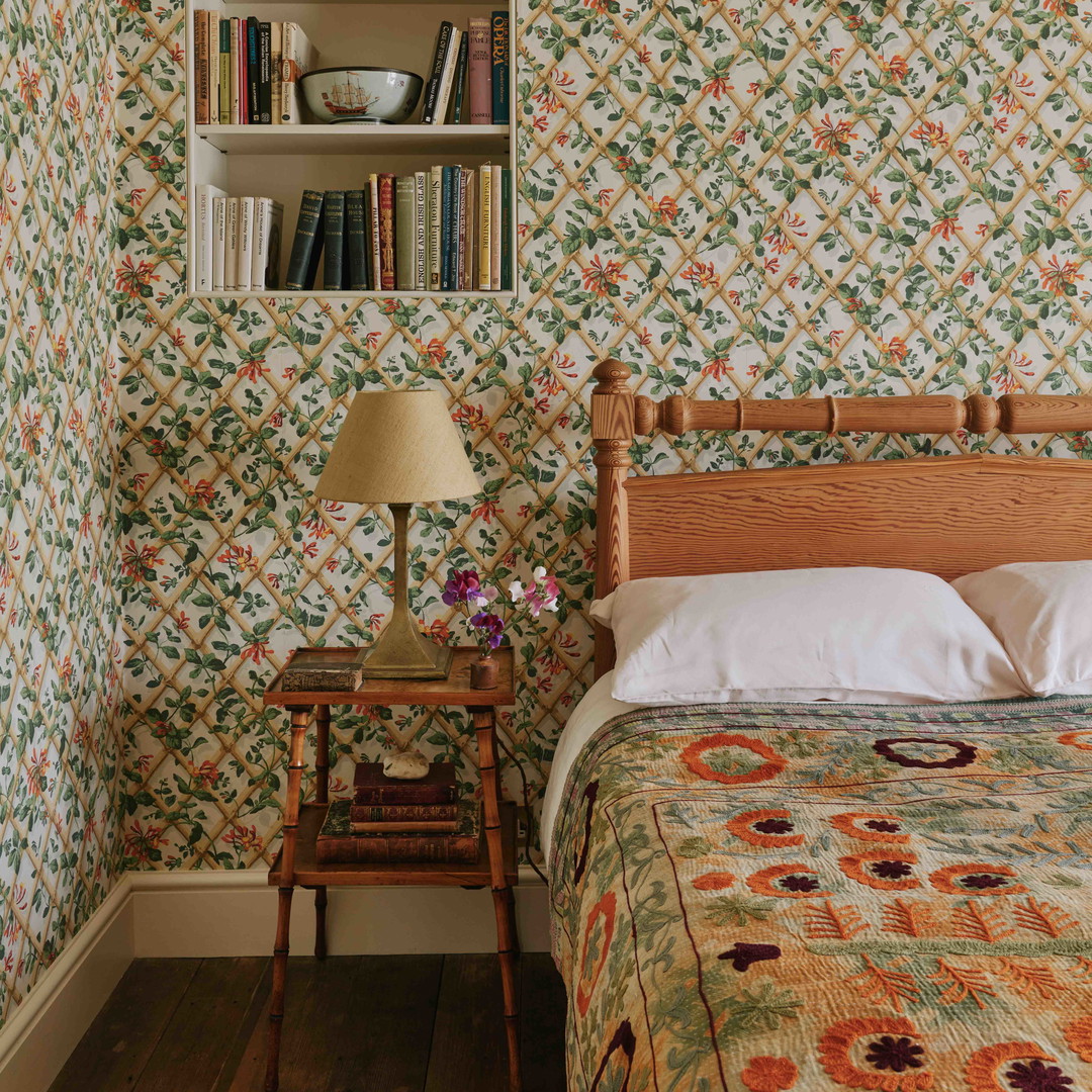 a bedroom with a bed and a book shelf