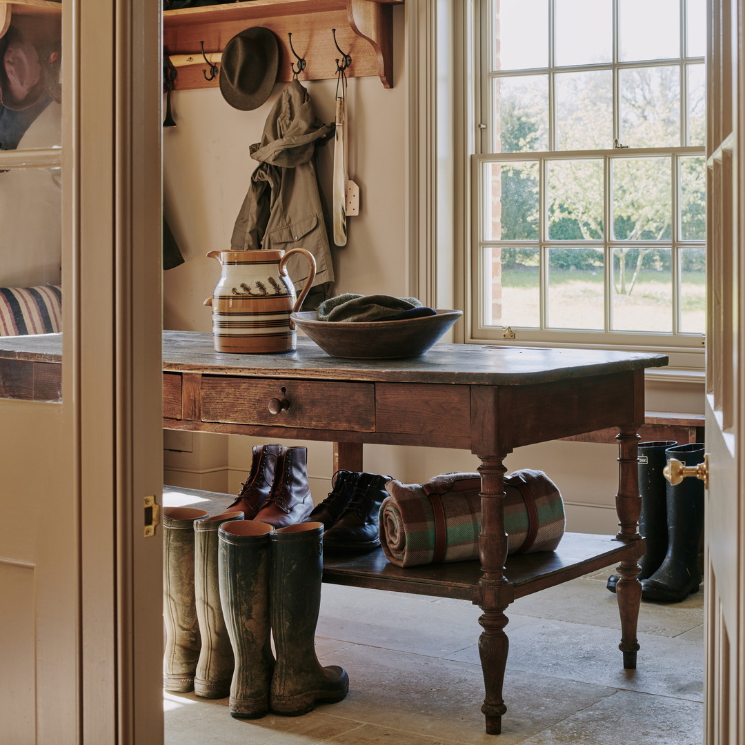 a room with a table and a bunch of boots