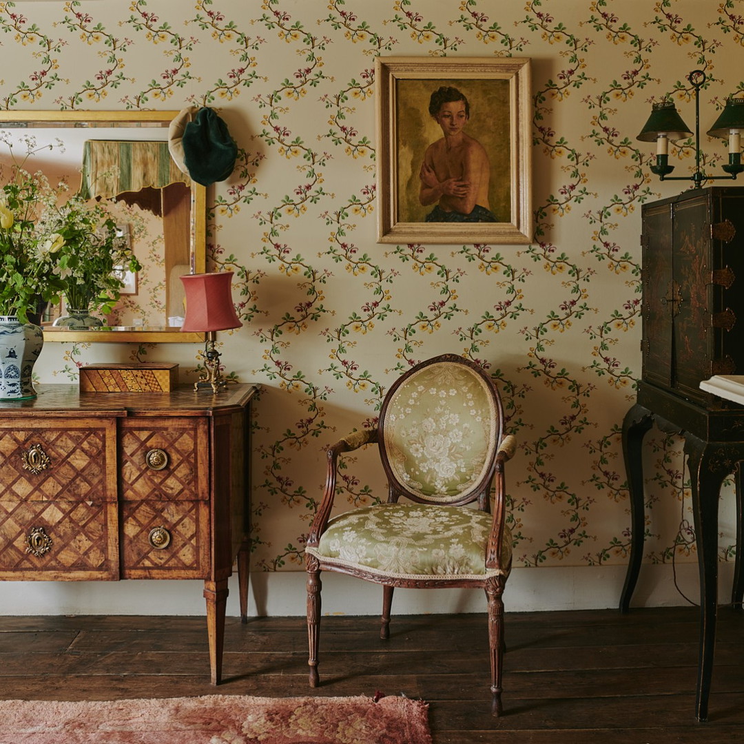 a room with a chair and a painting on the wall