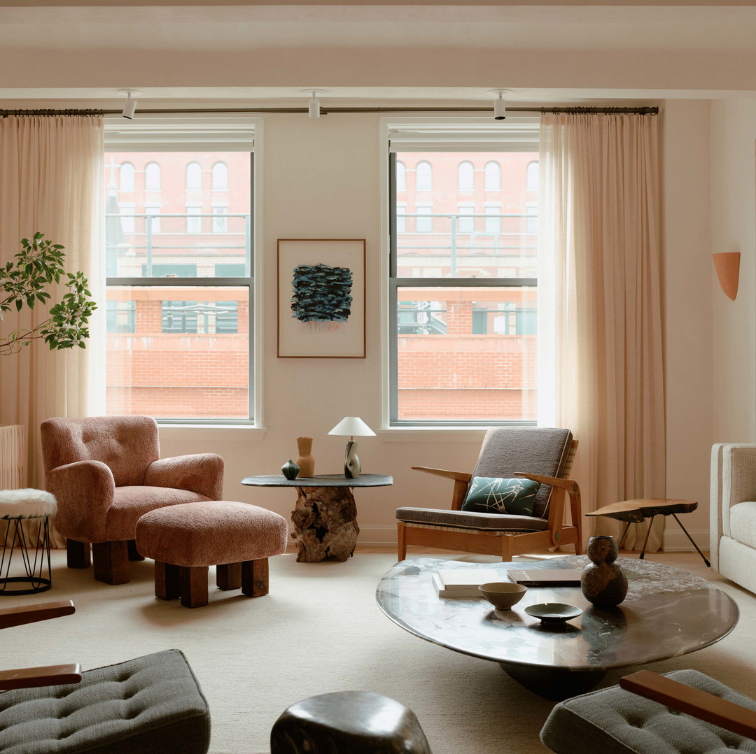 a living room filled with furniture and a large window