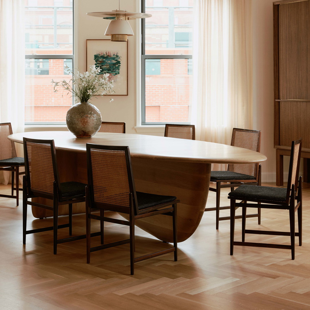 a dining room table with a vase on top of it