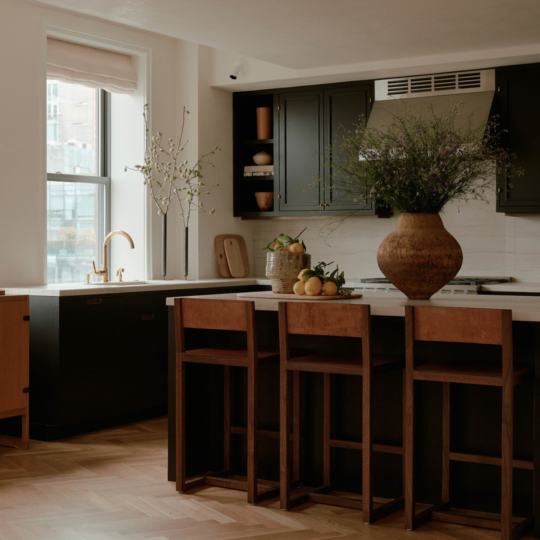 a kitchen with a center island next to a window