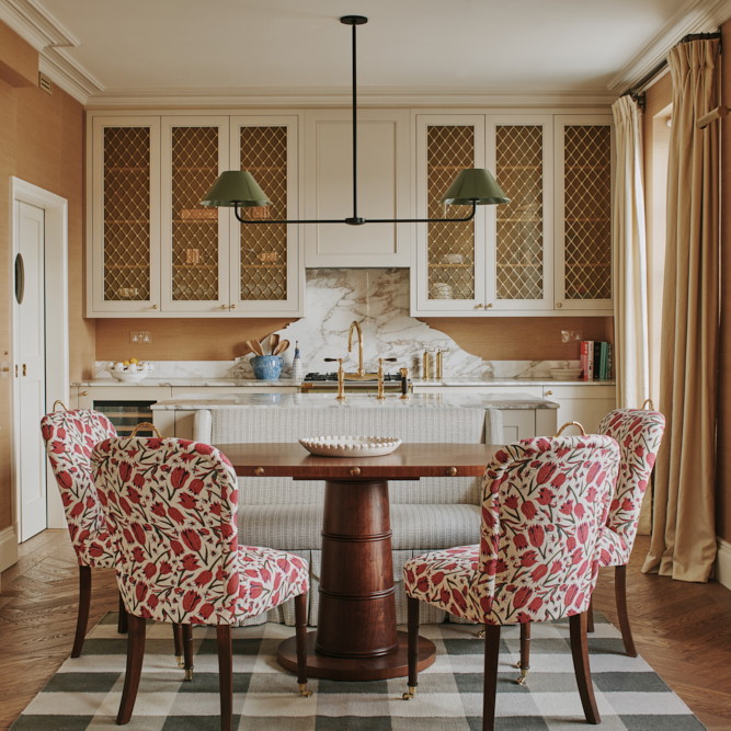 a kitchen with a table, chairs, cabinets and a sink