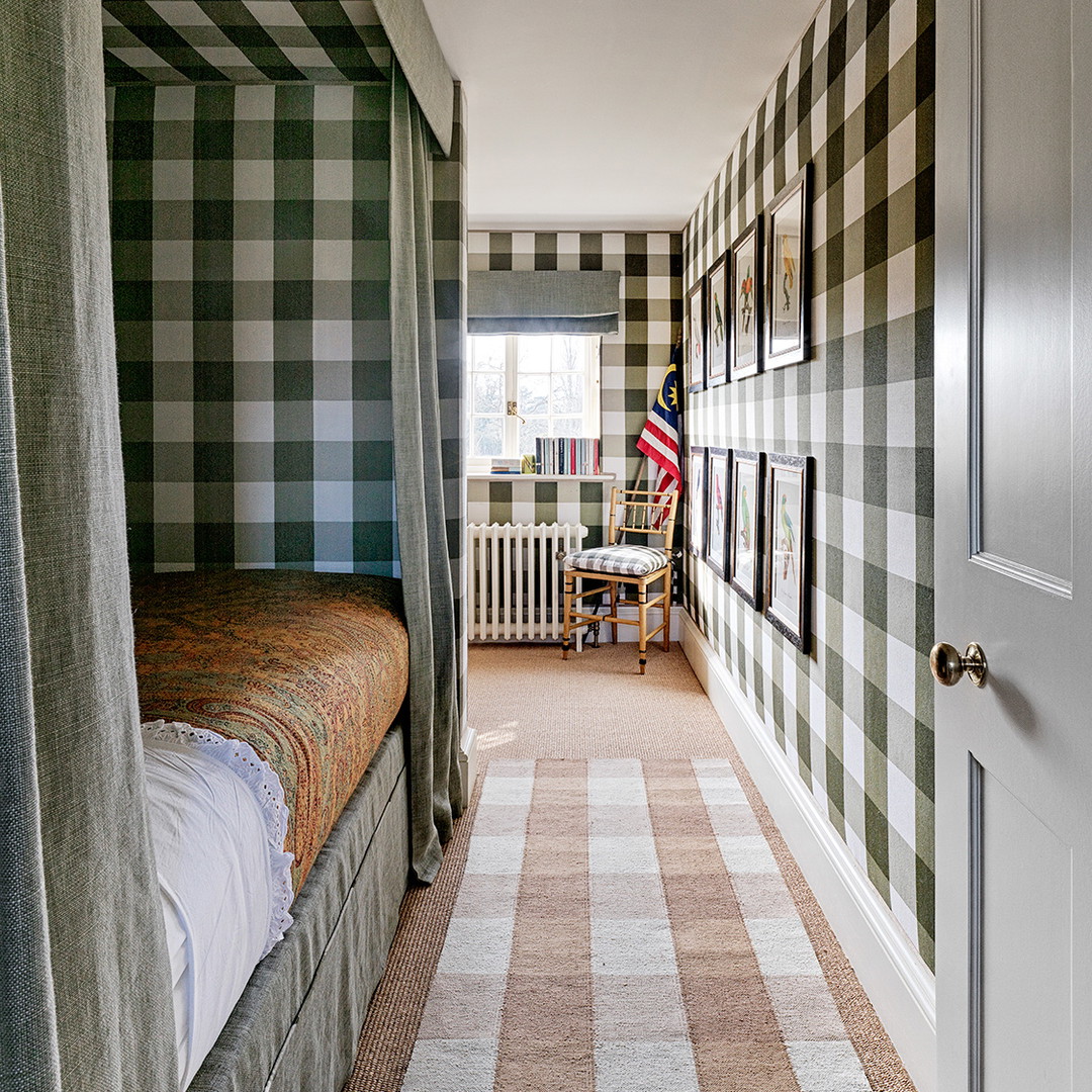 a bedroom with a checkered wall and a bed