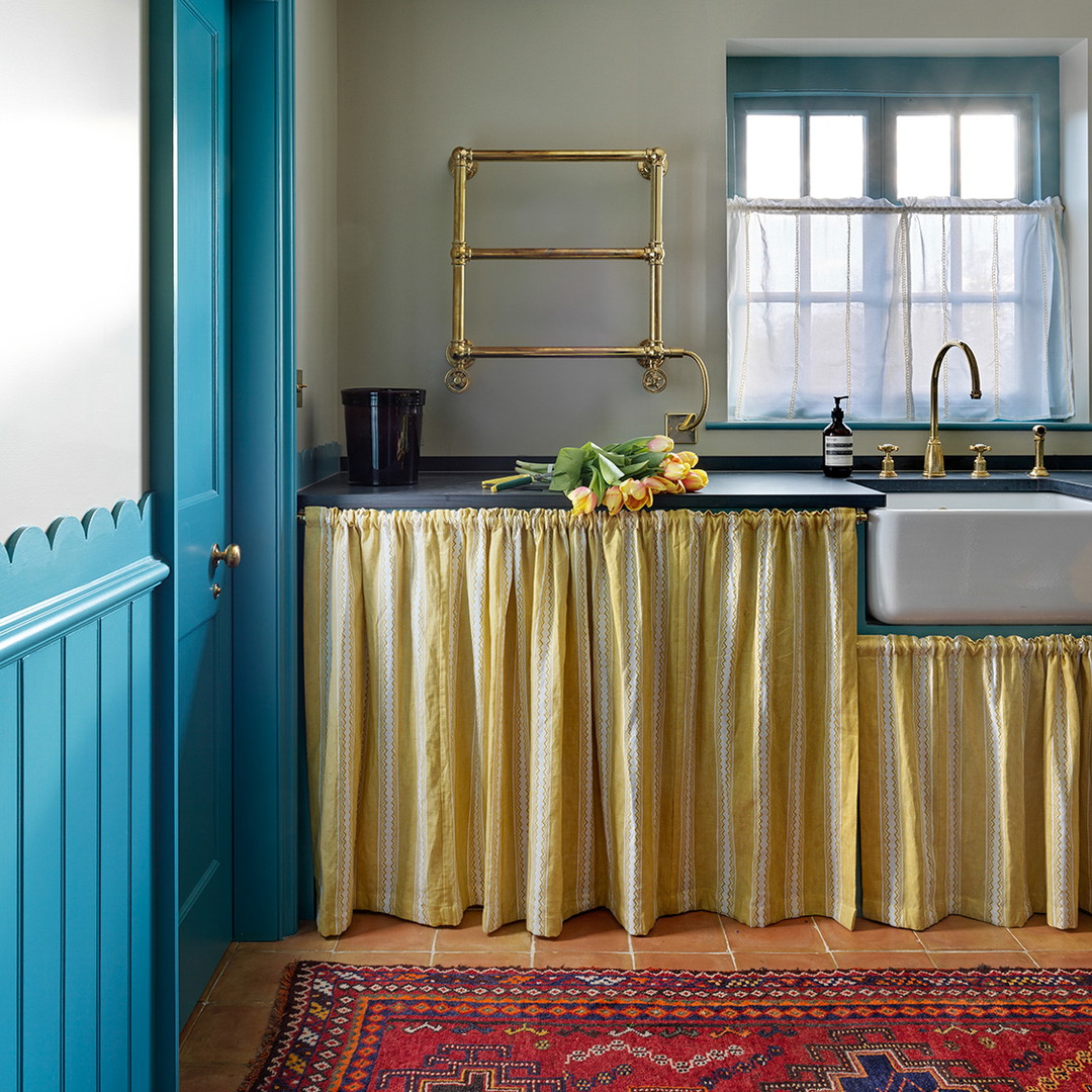 a kitchen with a sink and a blue door