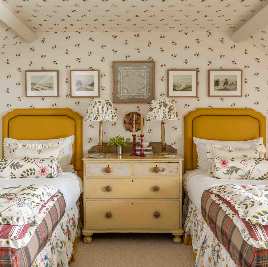 a bedroom with two beds and a dresser