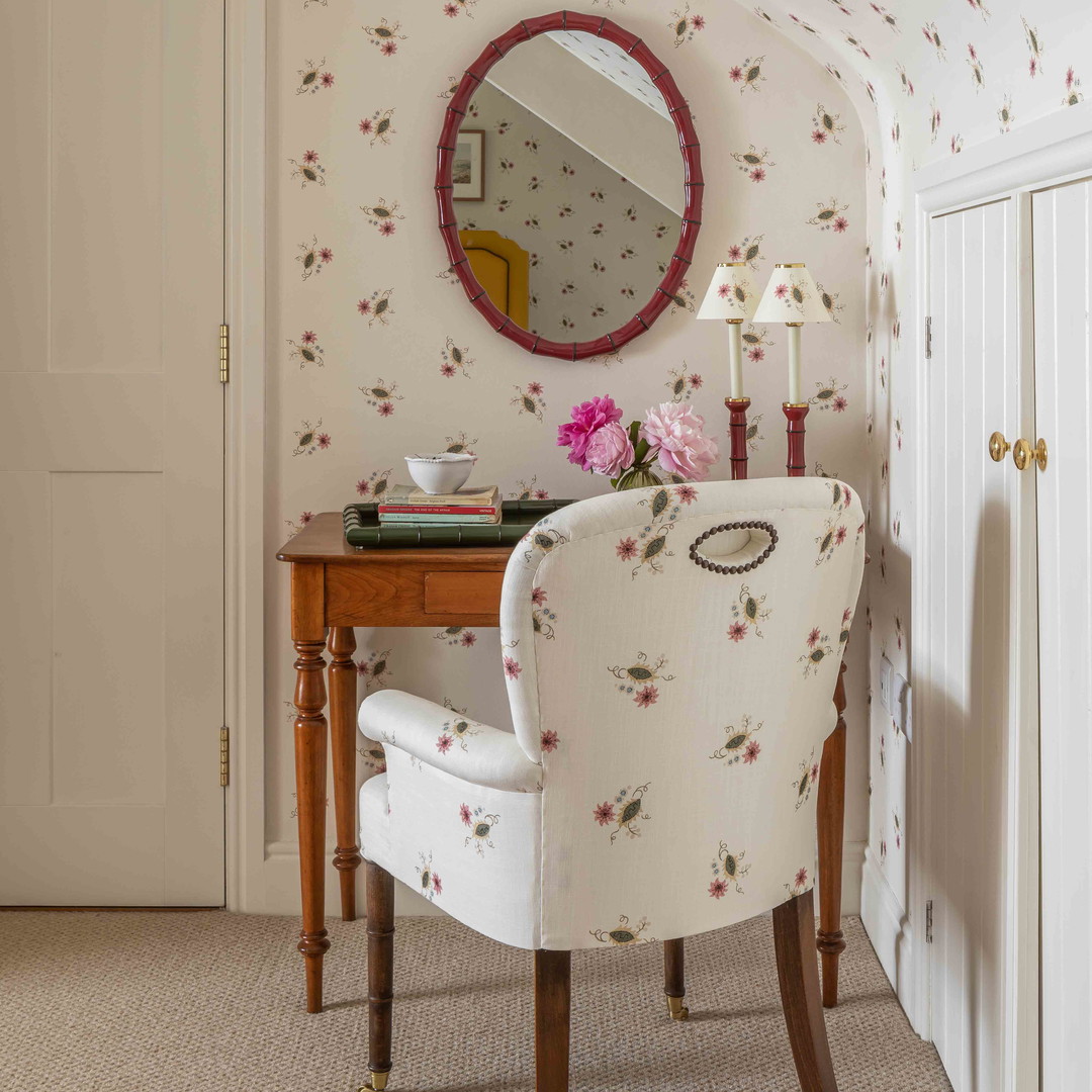 a white chair sitting in a room next to a table