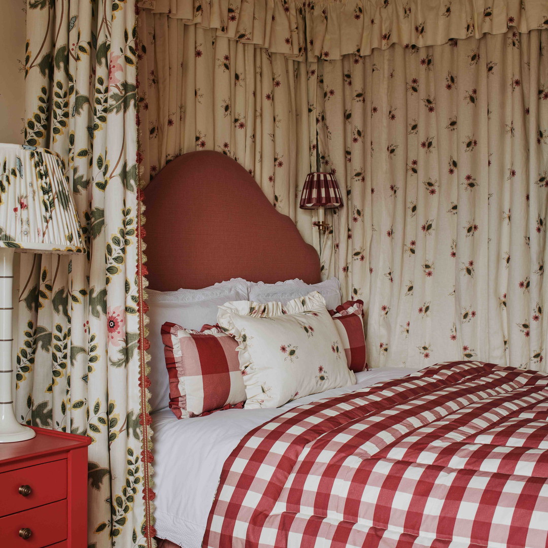 a red and white checkered bed in a bedroom