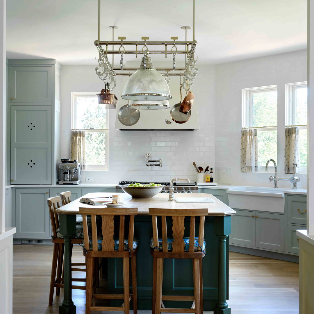 a kitchen with a center island with chairs