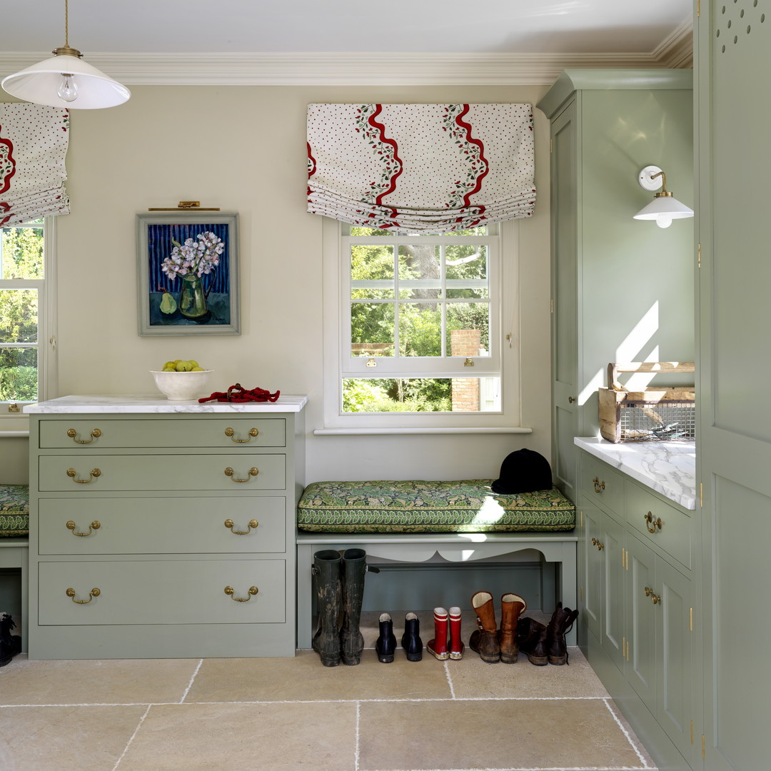 a kitchen with green cabinets and a window