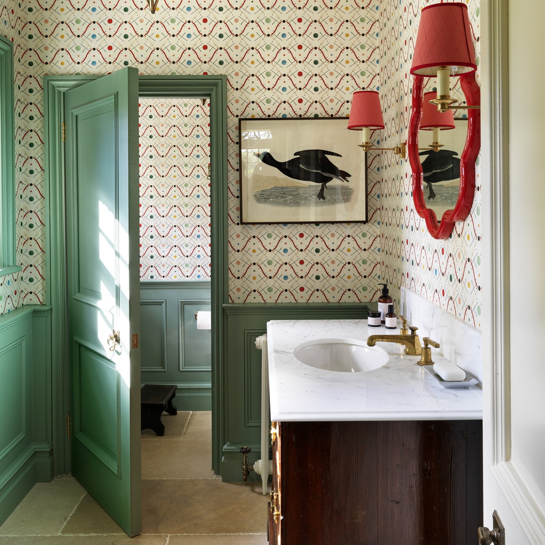 a bathroom with a green door and a white sink