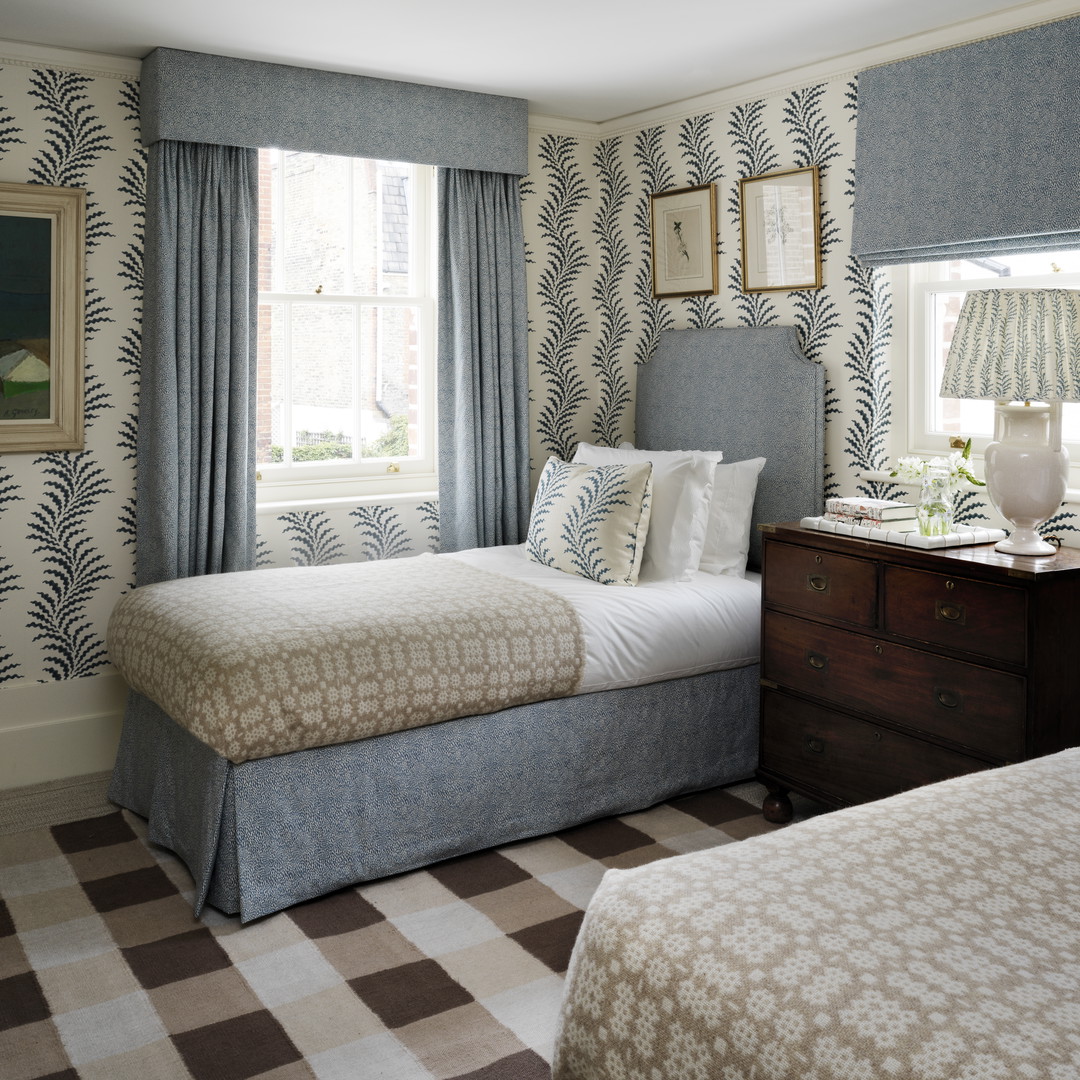 a bedroom with two beds and a checkered floor