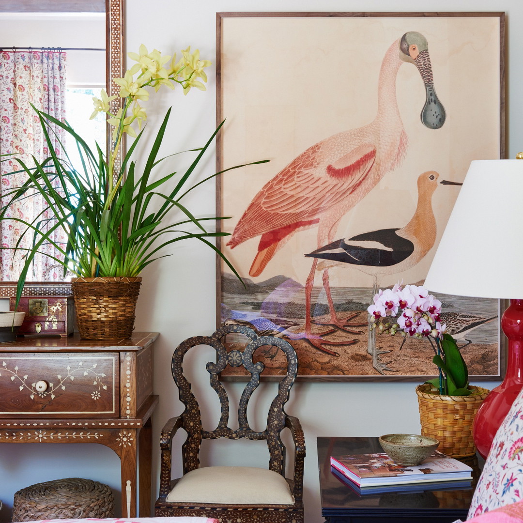 a living room with a chair and a painting on the wall