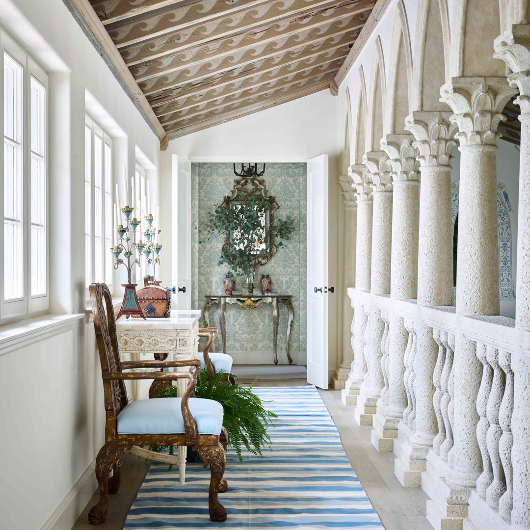 a hallway with a blue and white striped rug