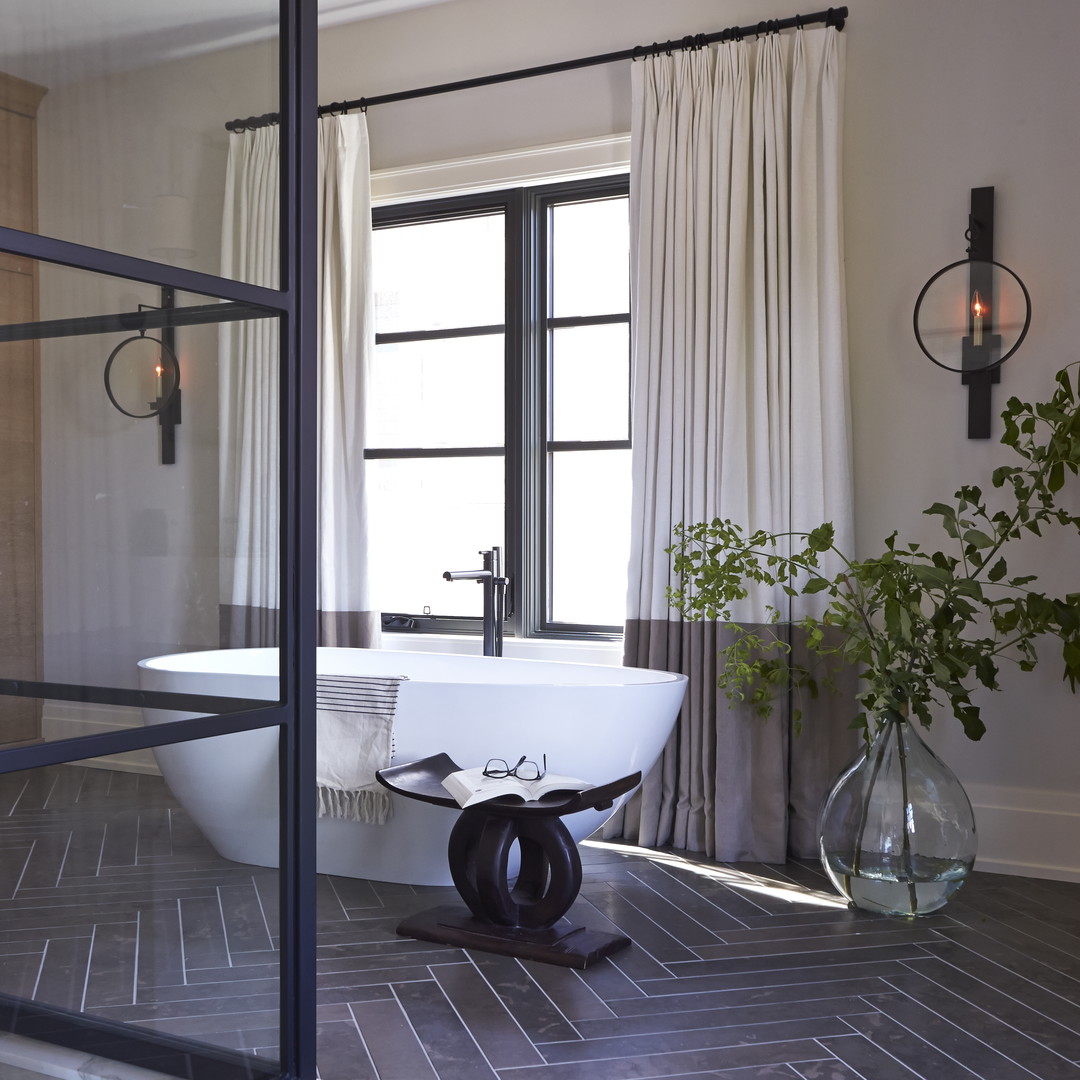 a bathroom with a tub and a window