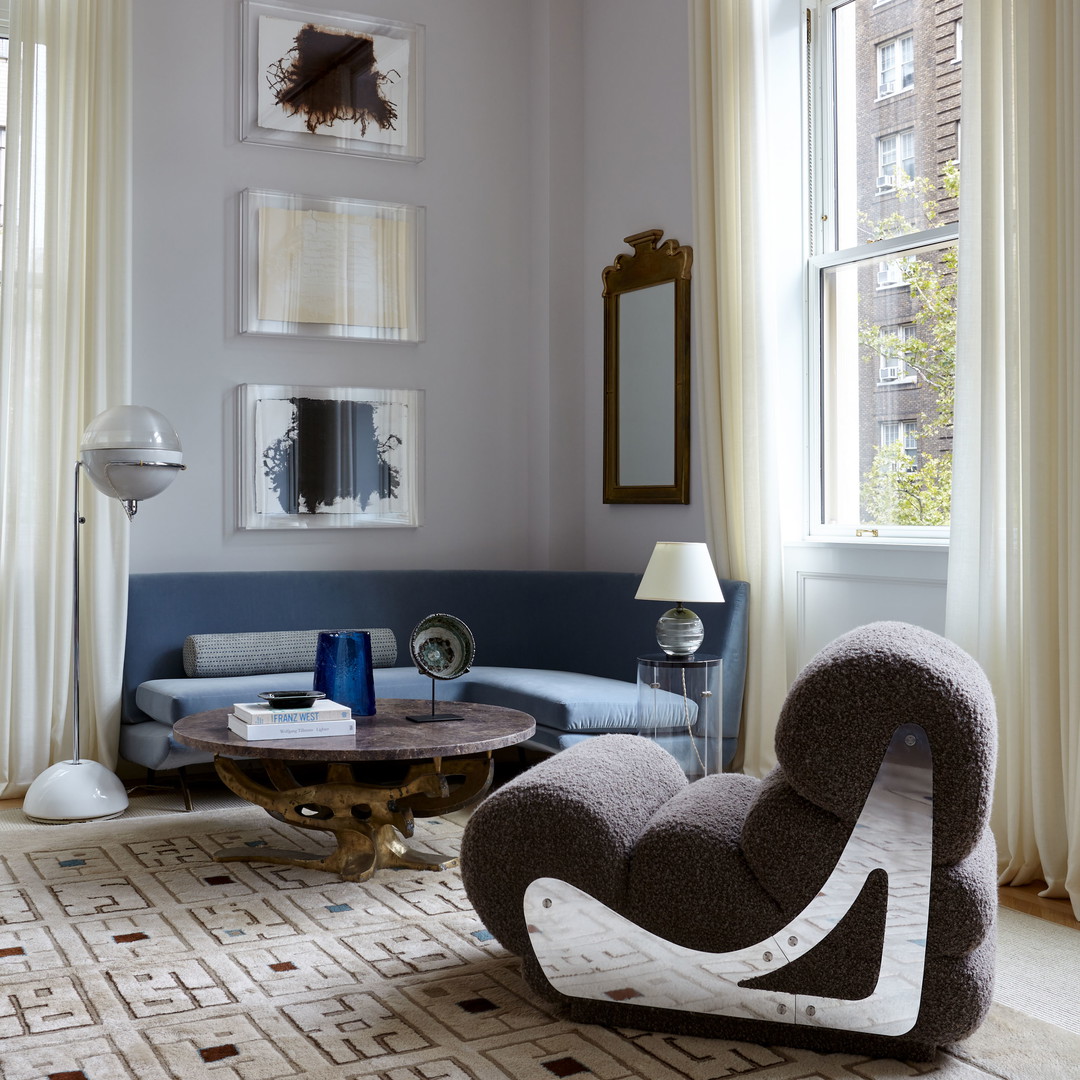 a living room with a blue couch and a table