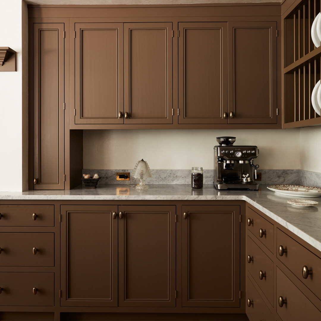 a kitchen with brown cabinets and white counter tops