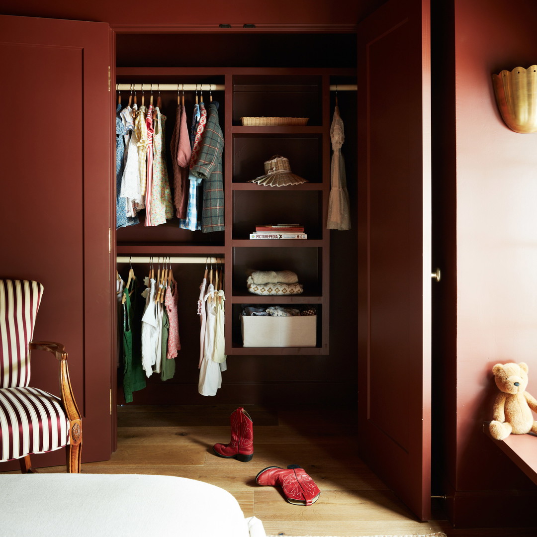 a room with a bed, a chair, and a closet