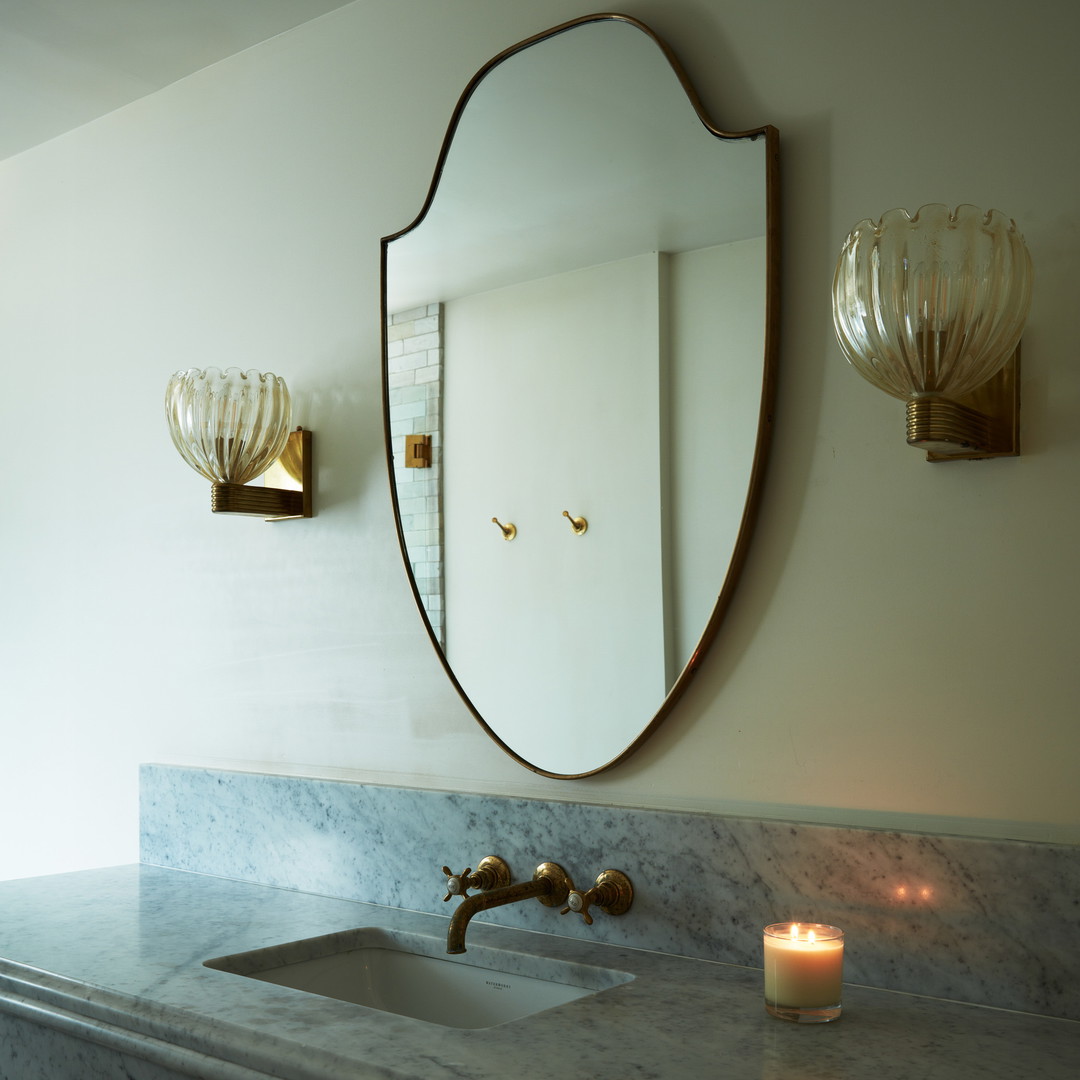 a bathroom sink with a large mirror above it