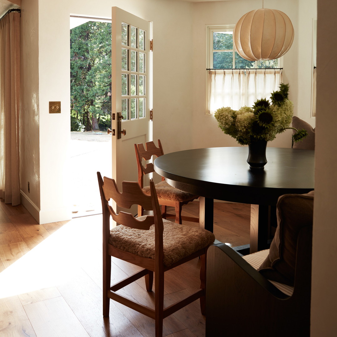 a dining room with a table and chairs