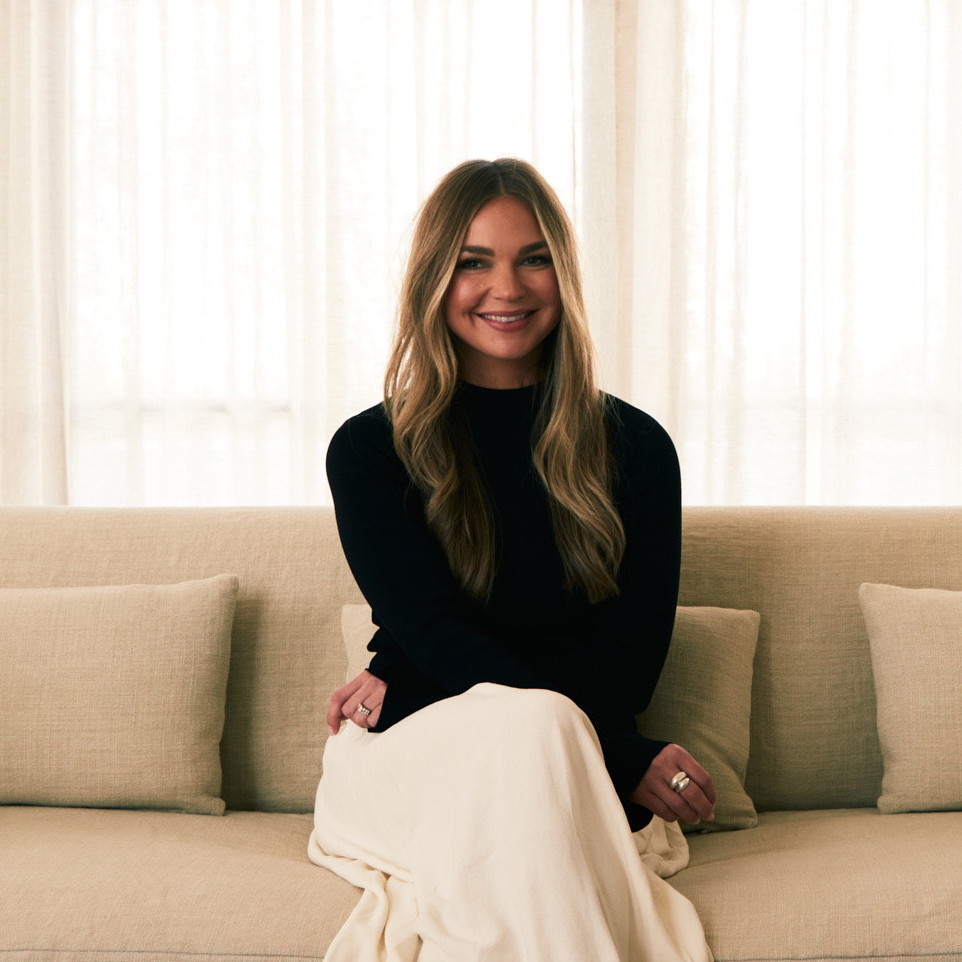 a woman sitting on a couch in a living room