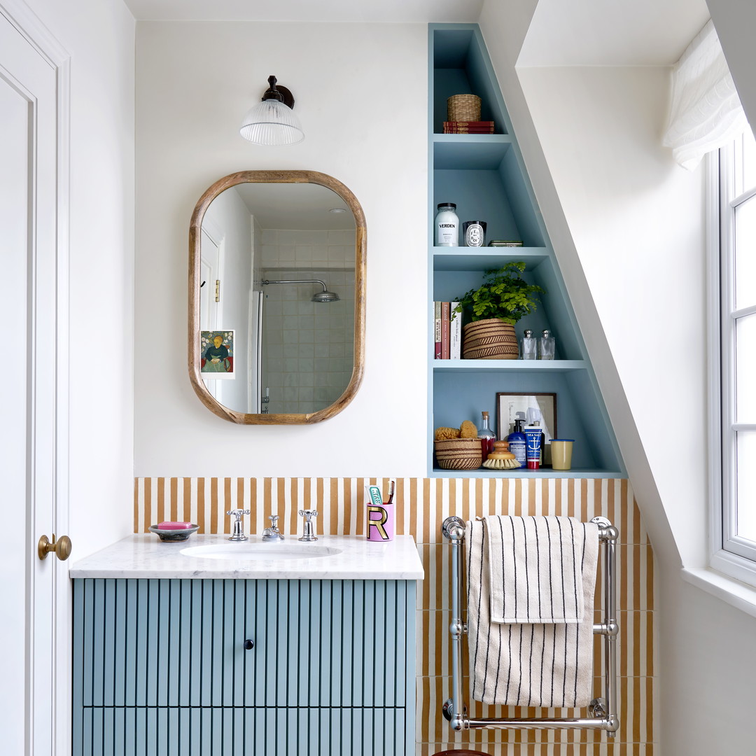 a bathroom with a sink, mirror and shelves