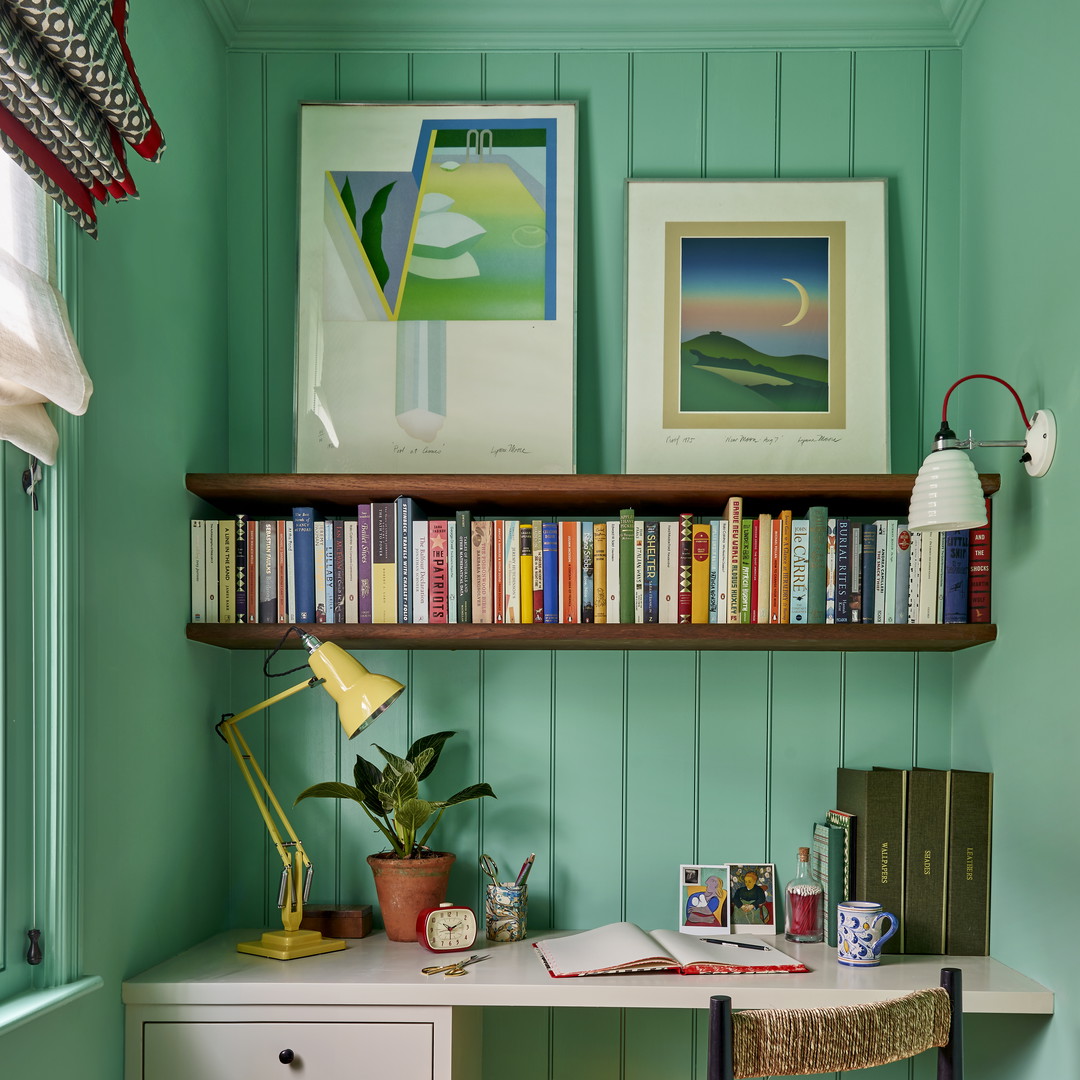 a home office with a desk and bookshelf