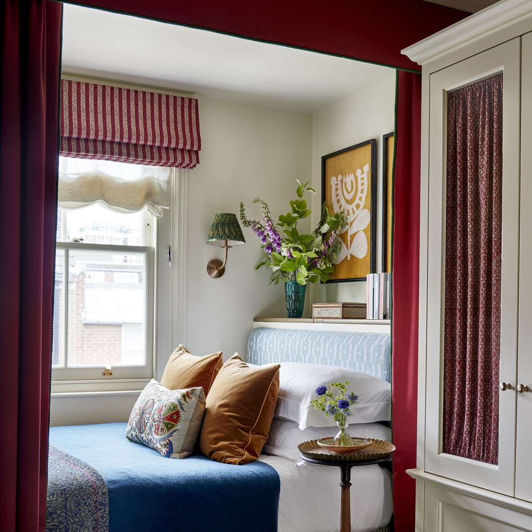 a bedroom with a bed, dresser, and window