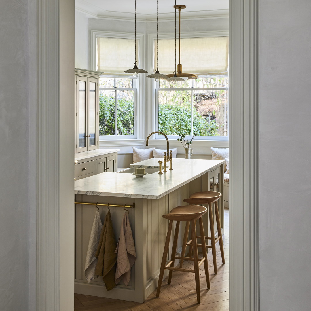 a kitchen with a center island with stools