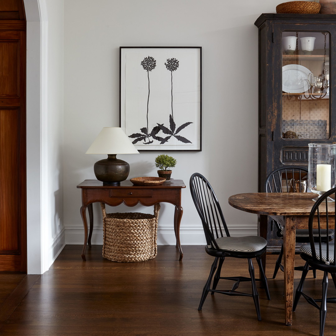 a dining room with a wooden table and chairs