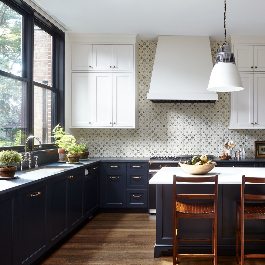 a large kitchen with a center island with chairs