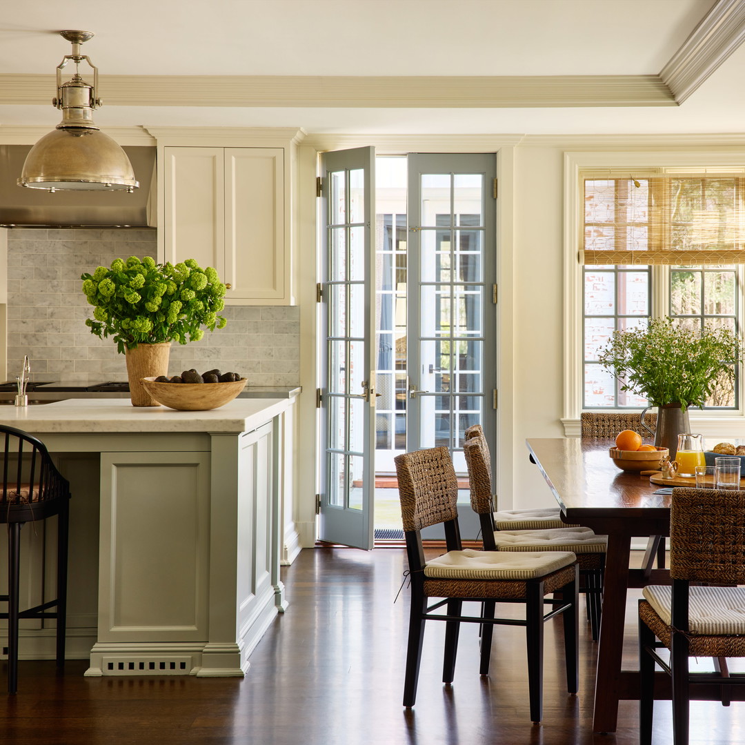 a kitchen filled with lots of furniture and a dining room table