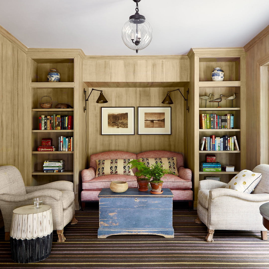 a living room filled with furniture and bookshelves