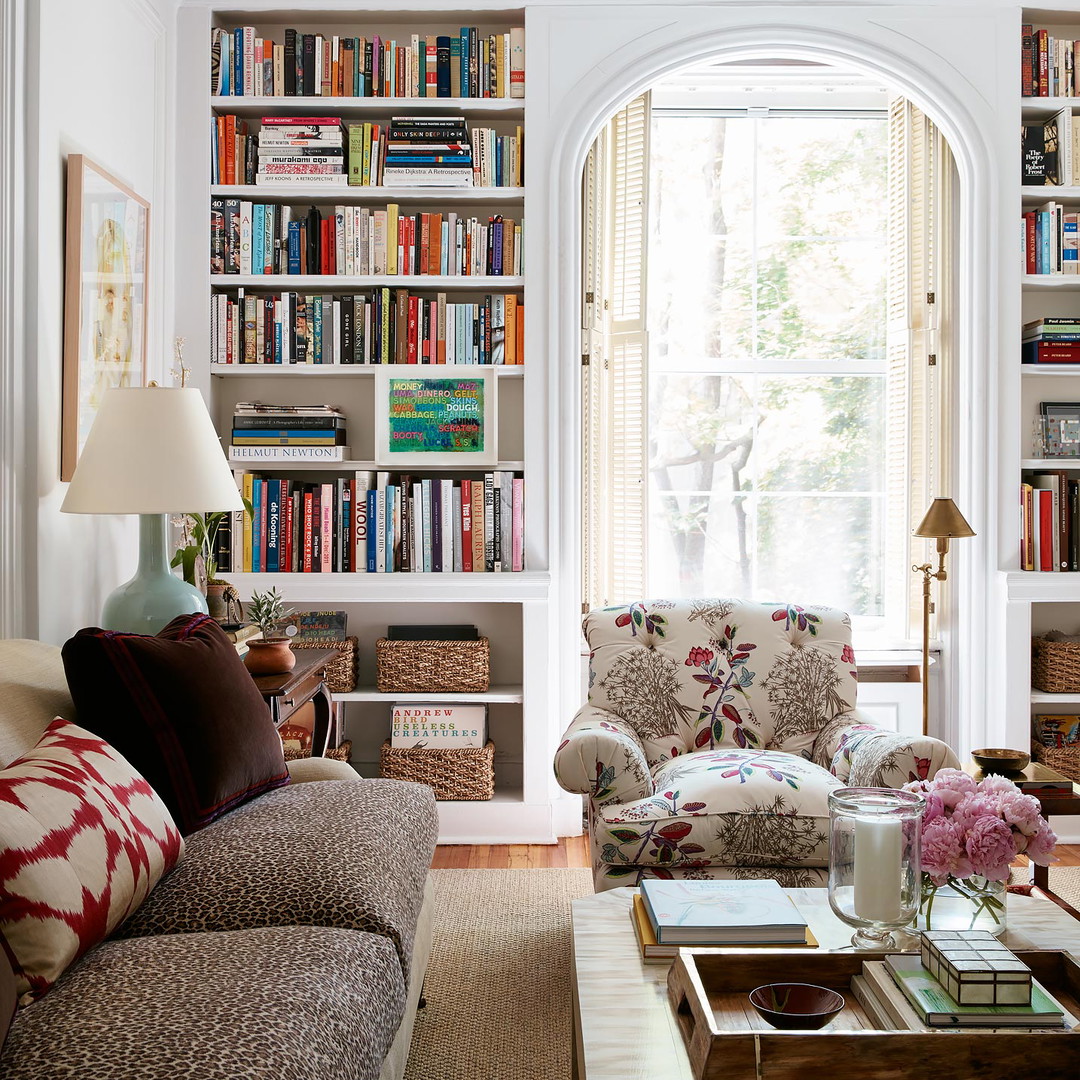 a living room filled with furniture and a large window