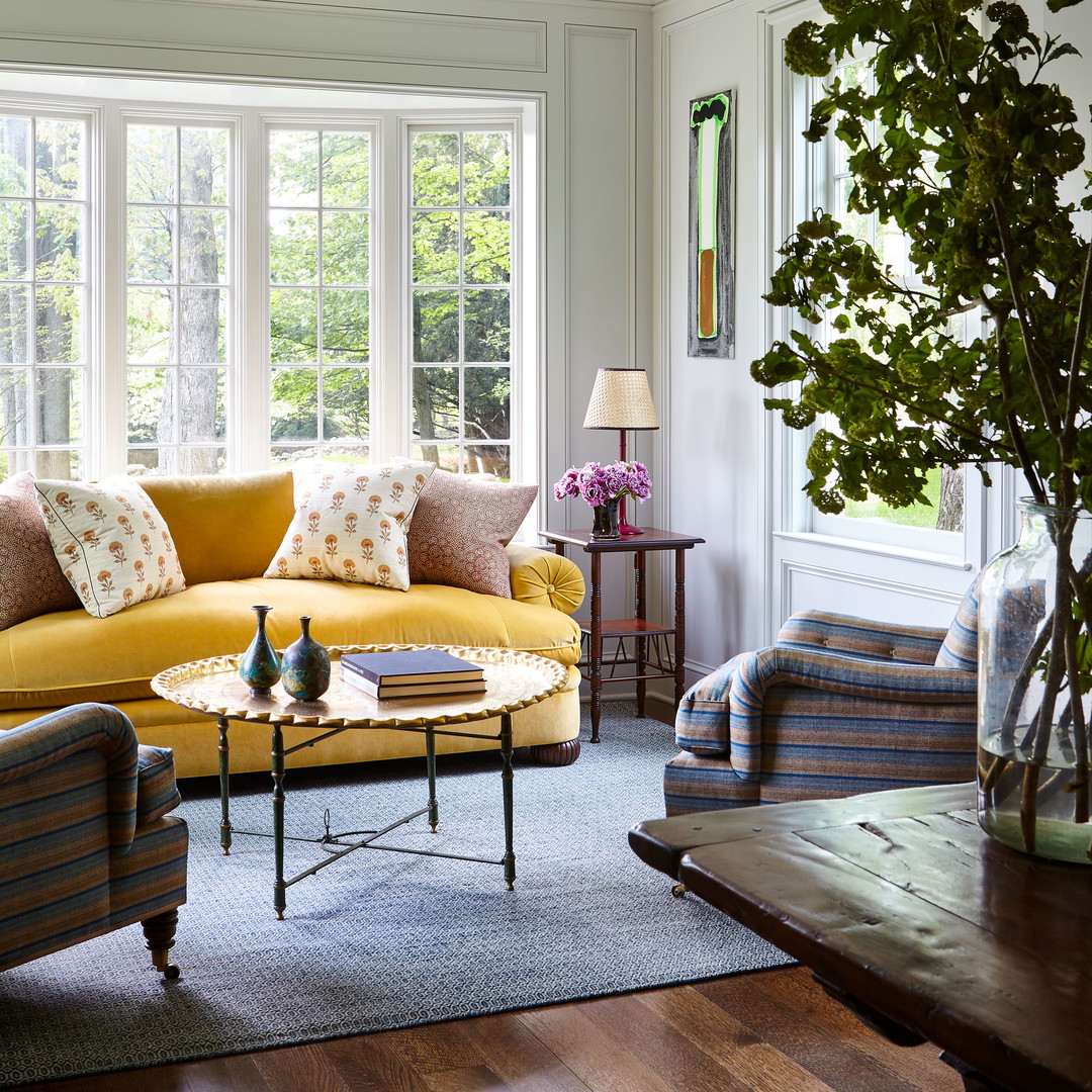 a living room filled with furniture and a large window