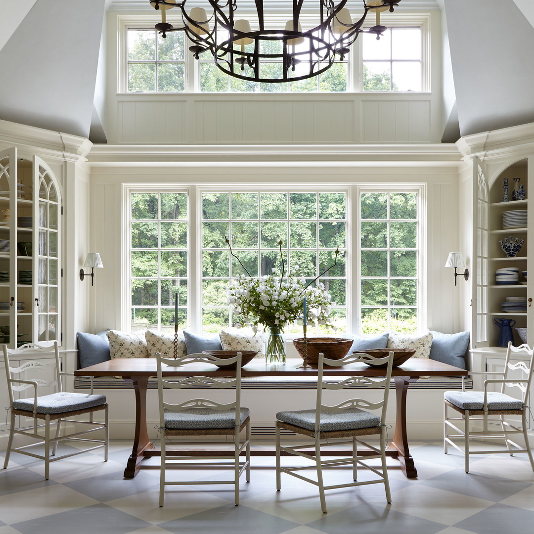 a dining room with a table and chairs and a chandelier