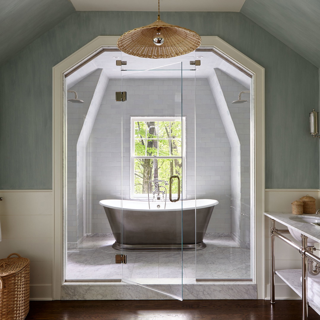 a bath room with a tub a sink and a mirror