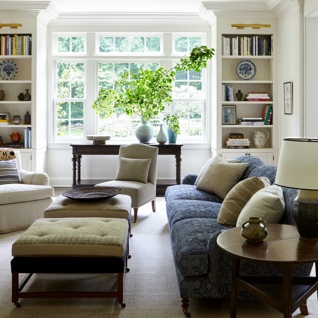 a living room filled with furniture and a large window