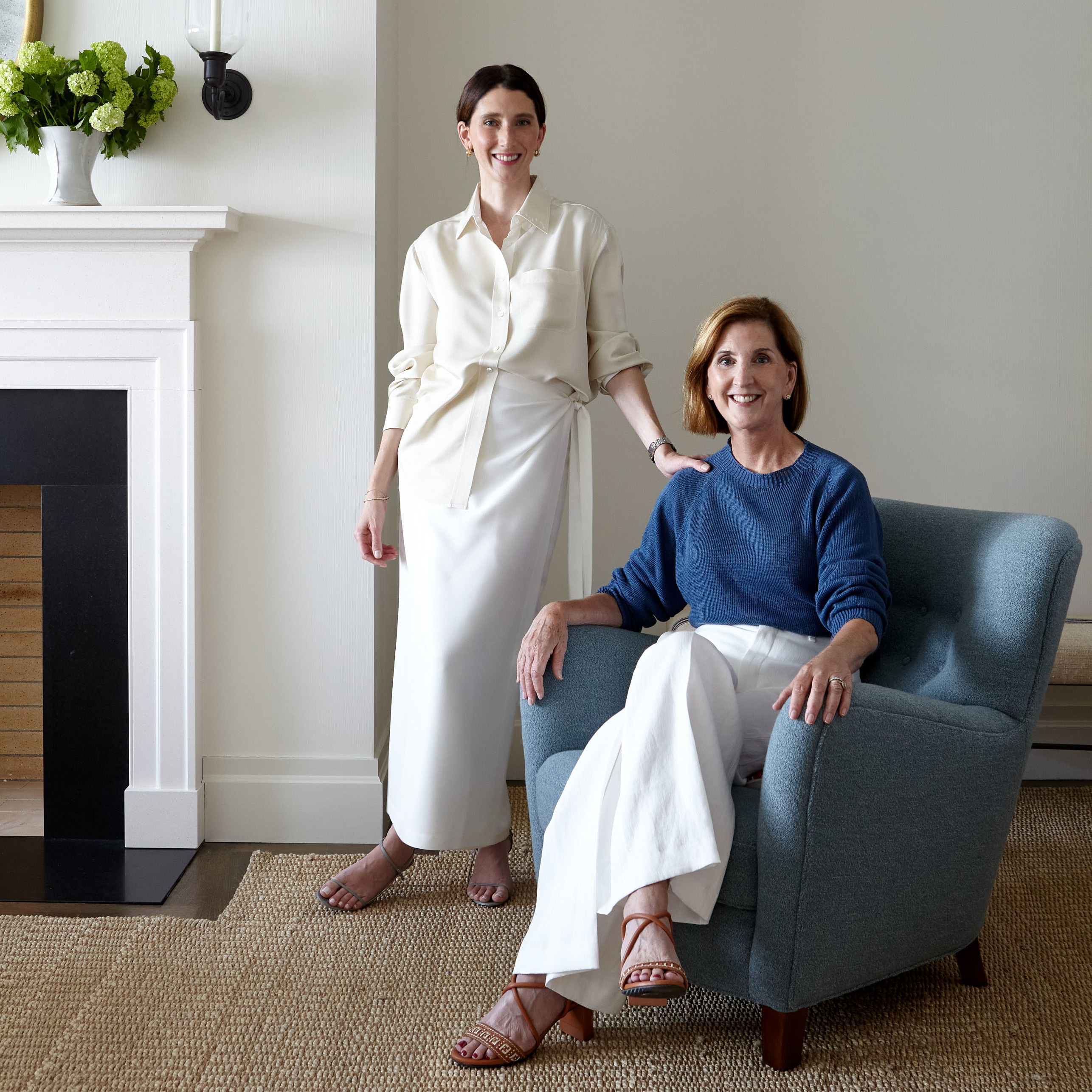 two women sitting in chairs in a living room