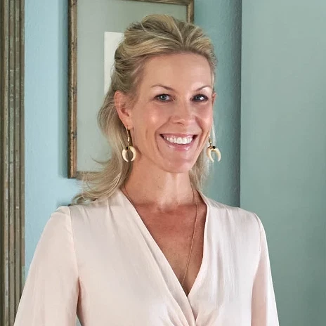 a woman standing in front of a bookshelf