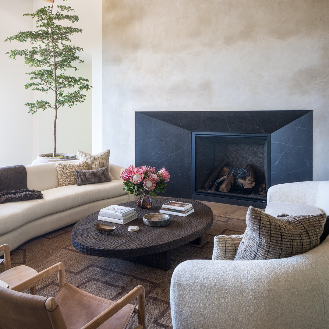 a living room filled with furniture and a fire place