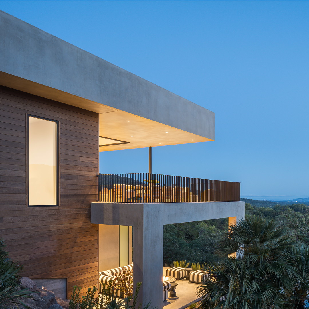 a house with a balcony and a view of the mountains