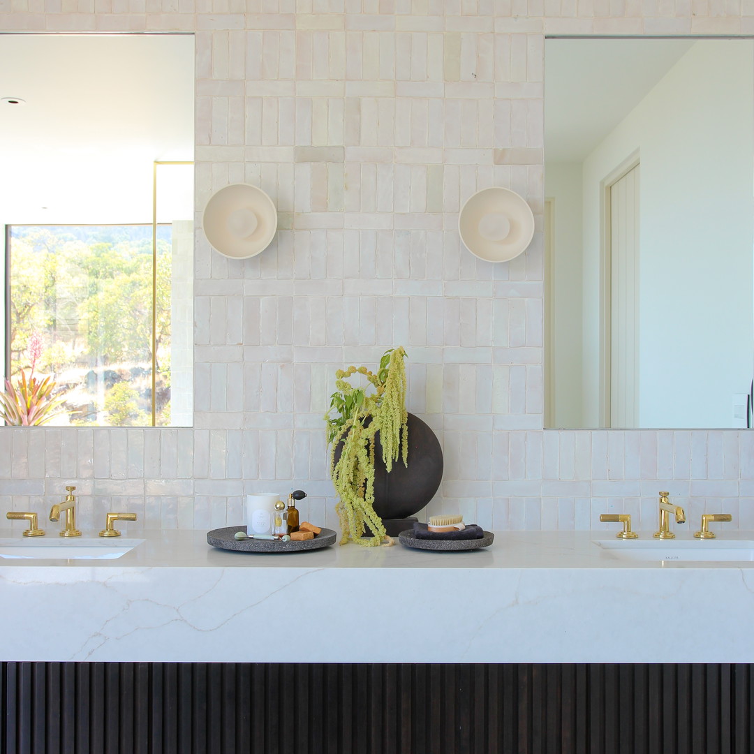 a bathroom with two sinks and a large mirror