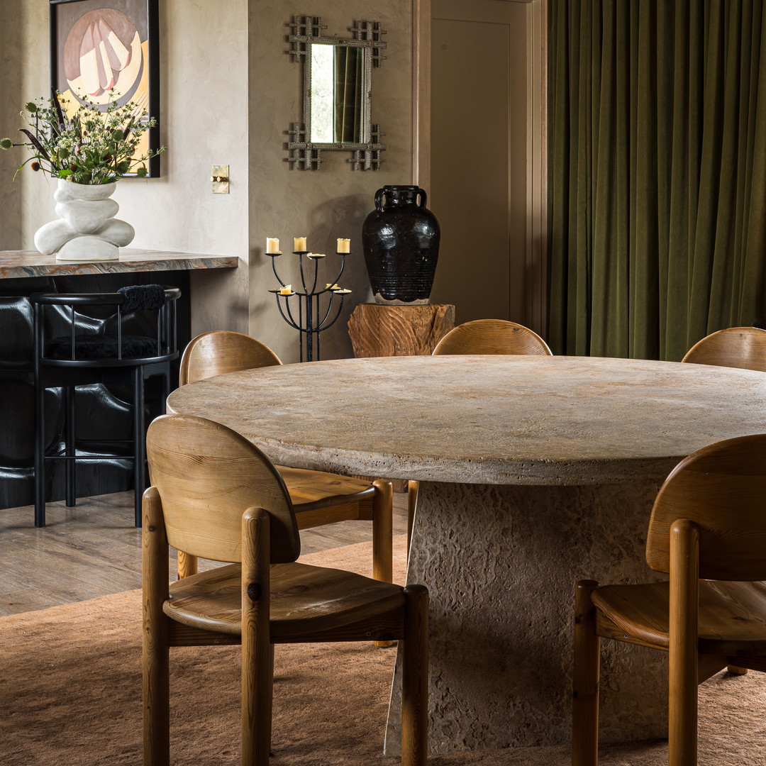 a dining room with a table and chairs