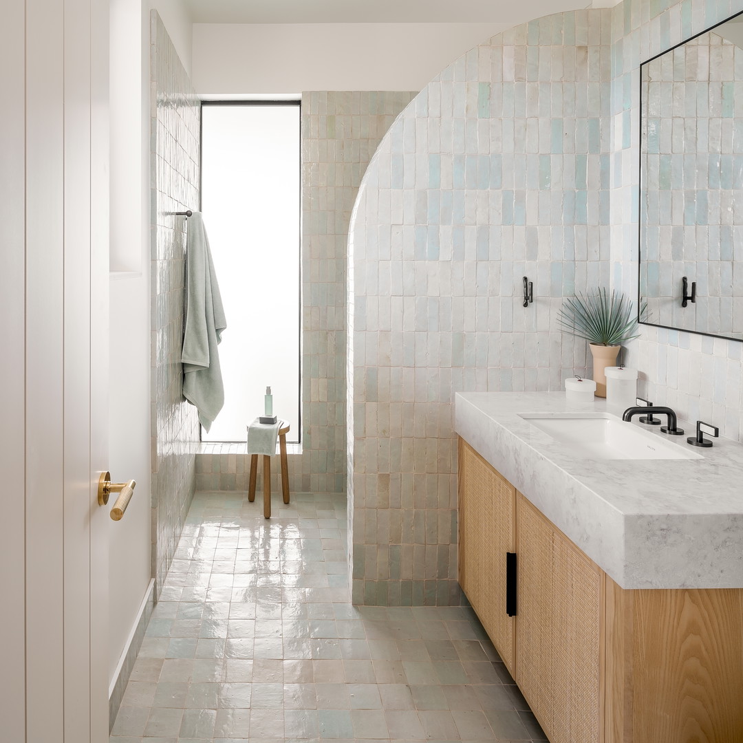 a bathroom with two sinks and a mirror