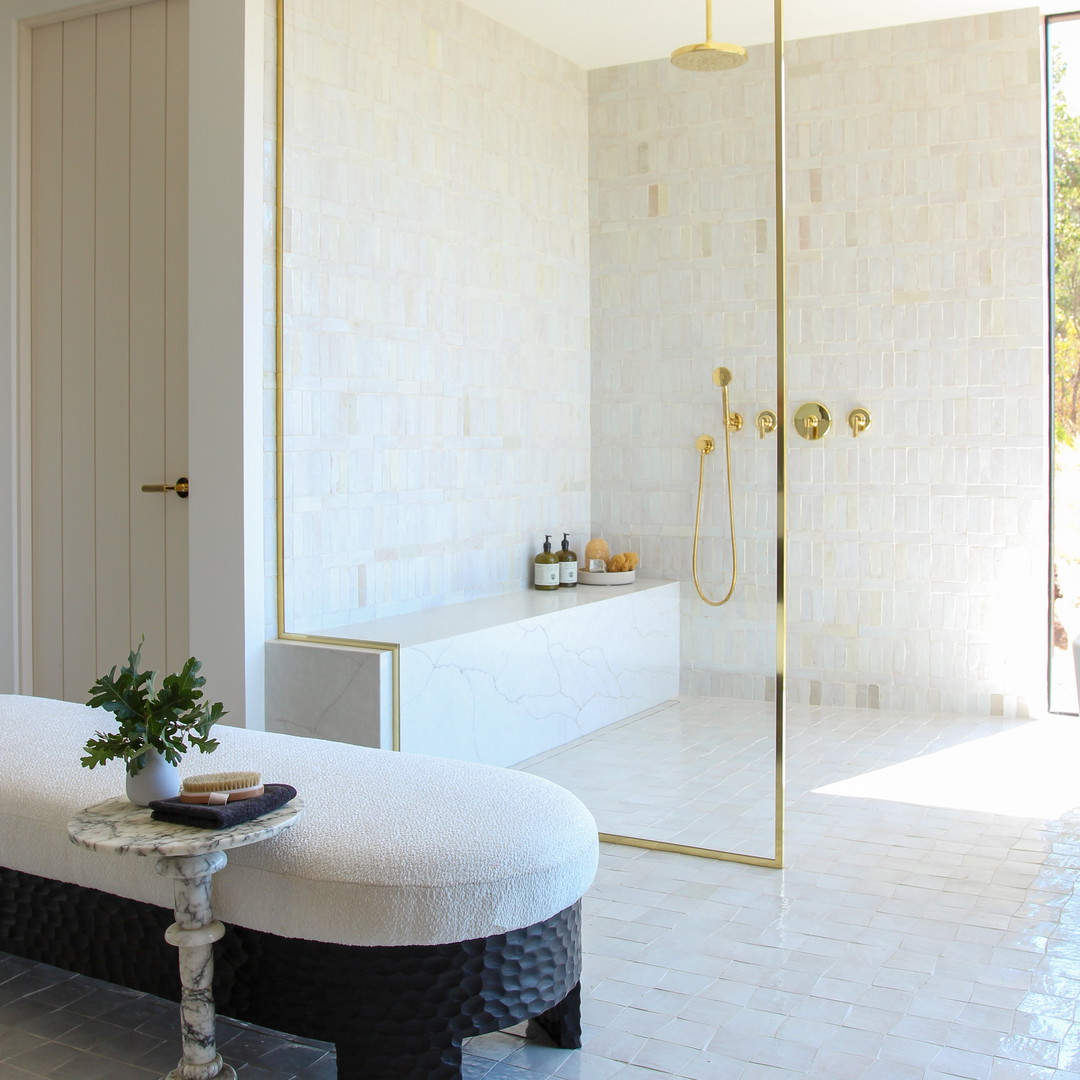 a bathroom with a large mirror and a bench