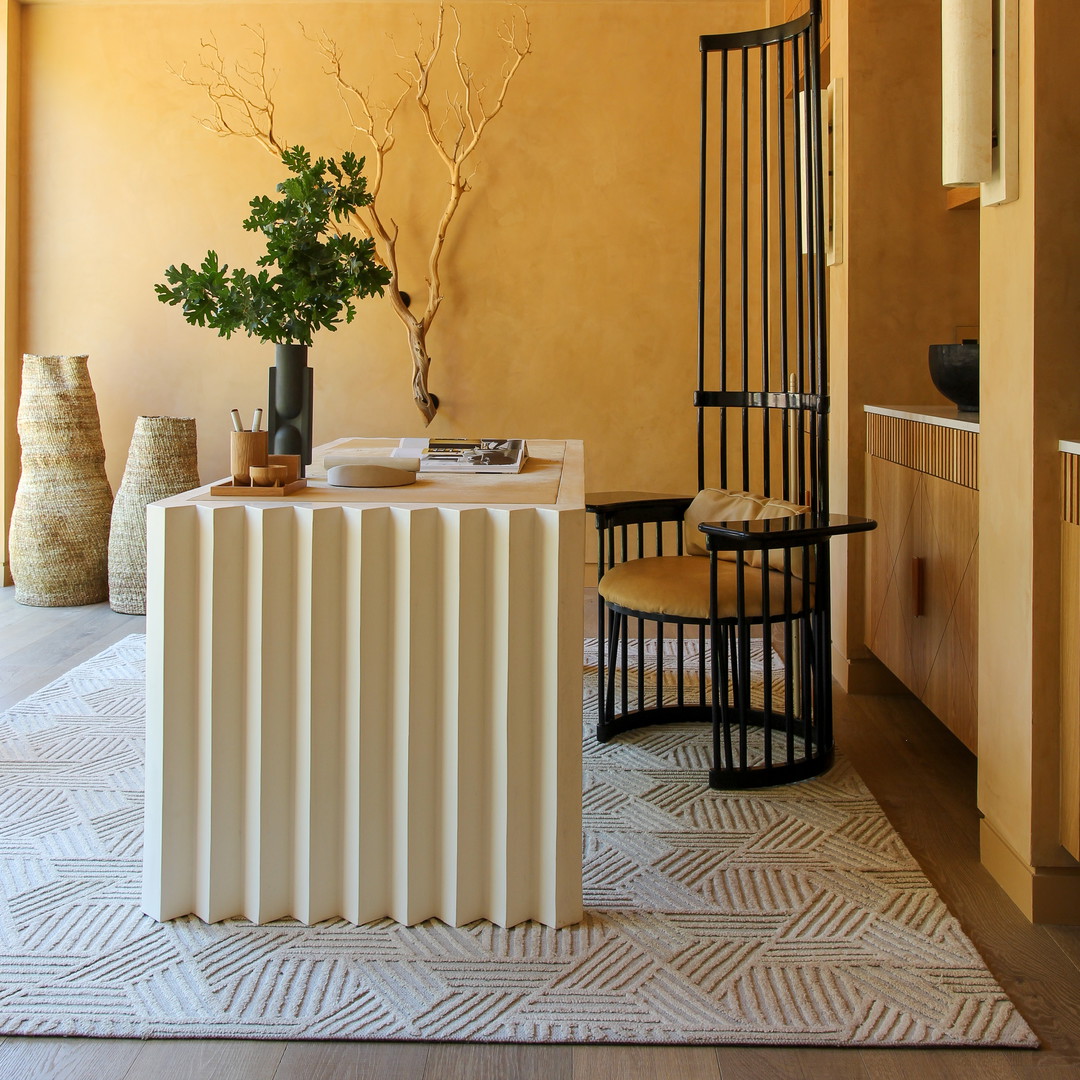 a living room with a radiator a table and chairs