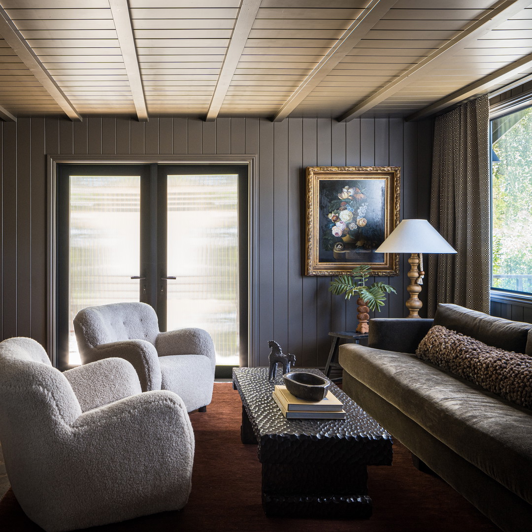 a living room filled with furniture and a large window