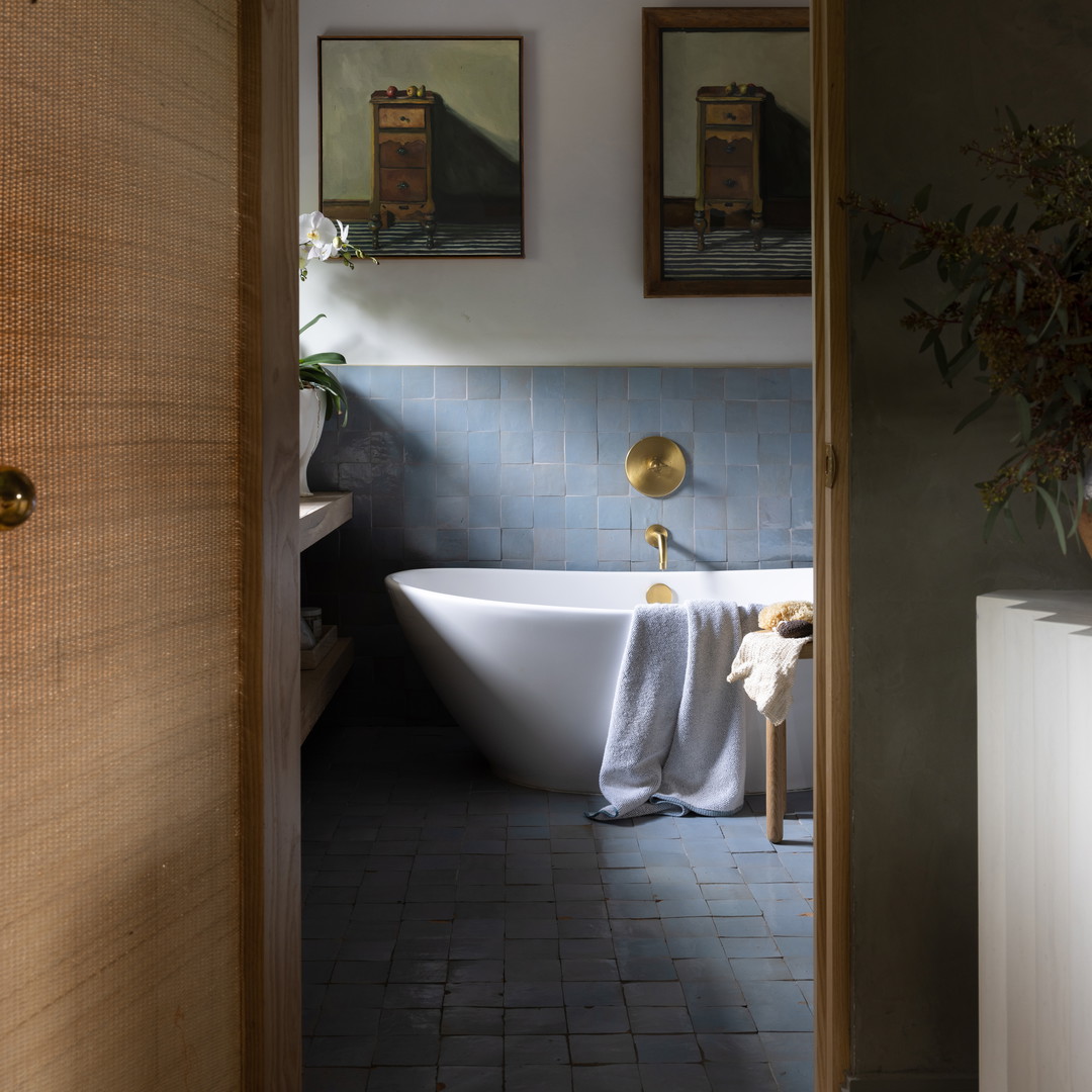 a white bath tub sitting next to a wooden door