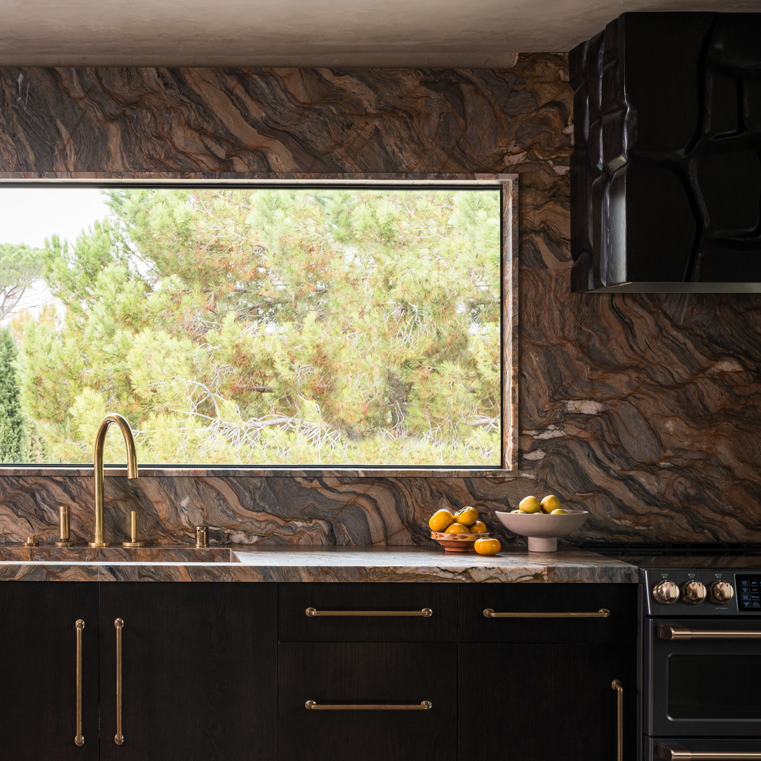 a kitchen with a sink, stove and a window